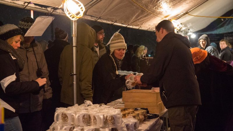 Families purchase souvenirs to support the annual Firebird Festival in Phoenixville. (Emily Cohen for WHYY)