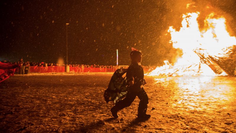 Scarlet Rogers, 6, dances as a phoenix/butterfly as the wooden phoenix burns behind her. (Emily Cohen for WHYY)