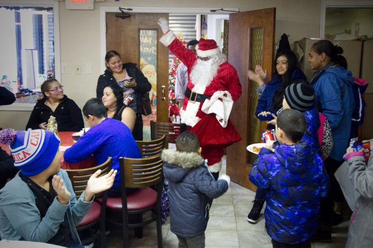 Santa makes an appearance at a  Christmas party for Puerto Rican families at the office of Association of Puerto Ricans In March, on Philadelphia Saturday, for about 20 families displaced from Puerto Rico after hurricane Maria. (Bastiaan Slabbers for WHYY)