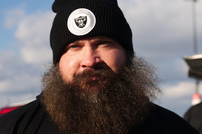 Raiders fan Steve Cooke, of California, sets up to tailgate outside the station as the Raiders are scheduled to take on the Eagles on Christmas Day.
