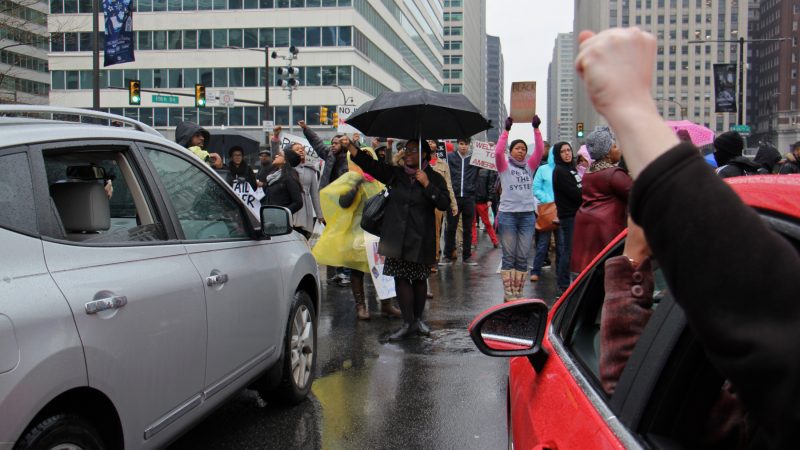Protesters block traffic on Arch Street near City Hall during an Inauguration Day march through Center City.. (Emma Lee/WHYY)