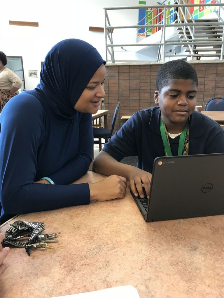 Teacher Syreeta Thomas works with Kahleel Odom during Ethel Allen Elementary School's hour of coding.