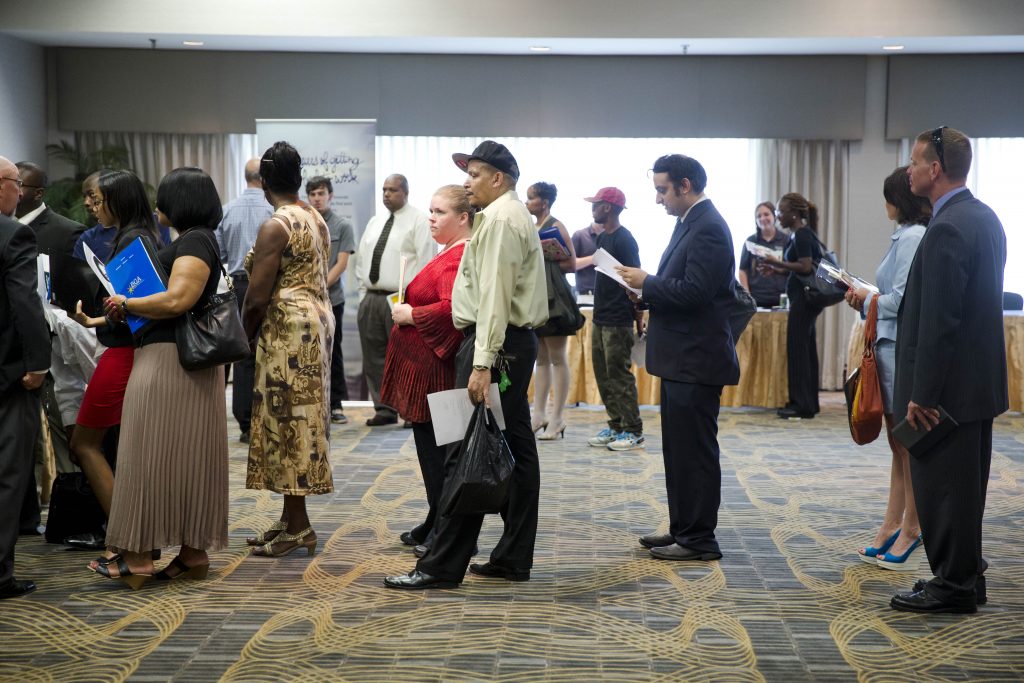 Unemployment Benefits People wait in line to meet with recruiters during a job fair in Philadelphia