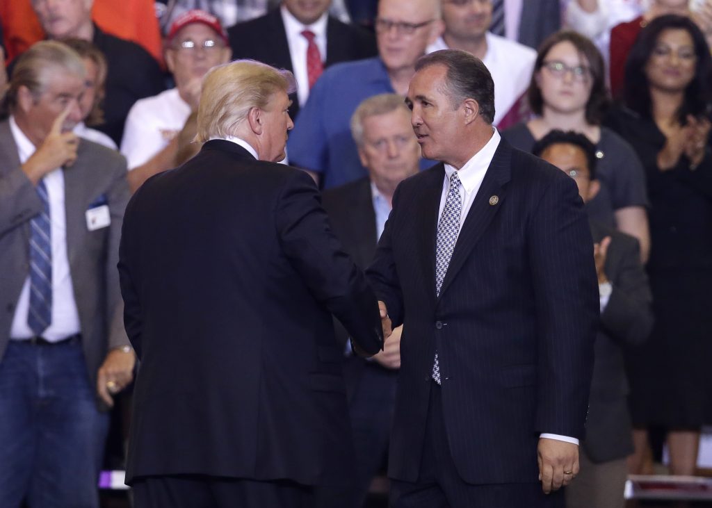 Trump President Donald Trump shakes hands with Arizona Representative Trent Franks during a rally at the Phoenix Convention Center, Tuesday, Aug. 22, 2017, in Phoenix.
