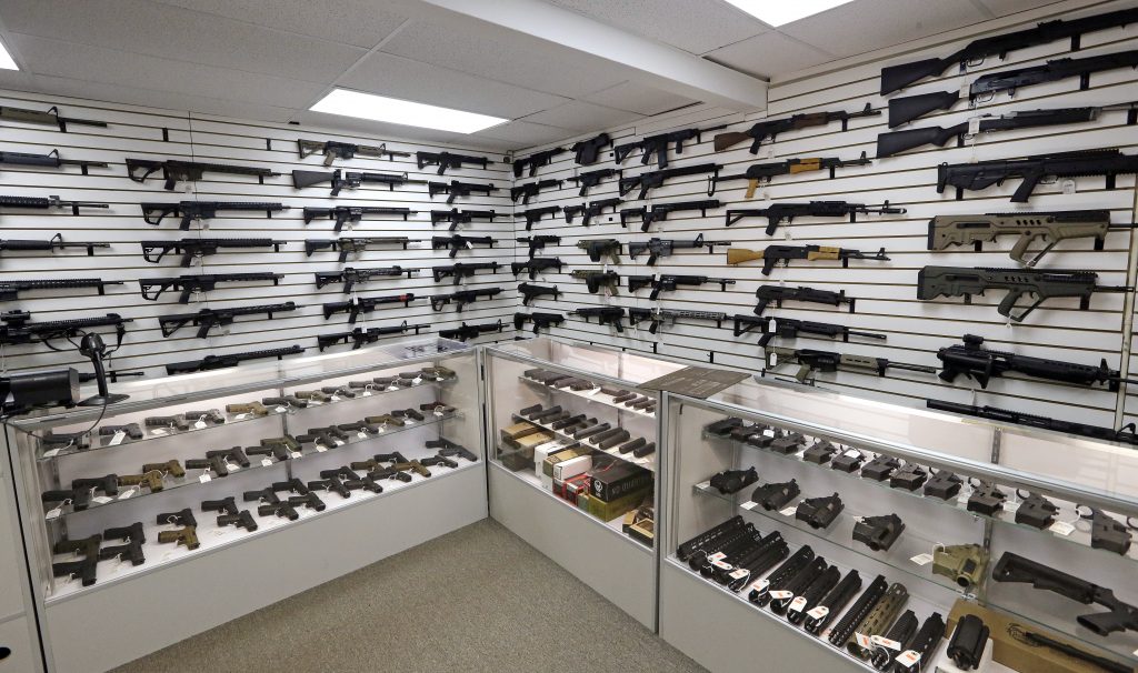Church Shooting Gun Debate Dozens of semi-automatic rifles line a pair of walls in a gun shop Tuesday, Nov. 7, 2017, in Lynnwood, Wash.