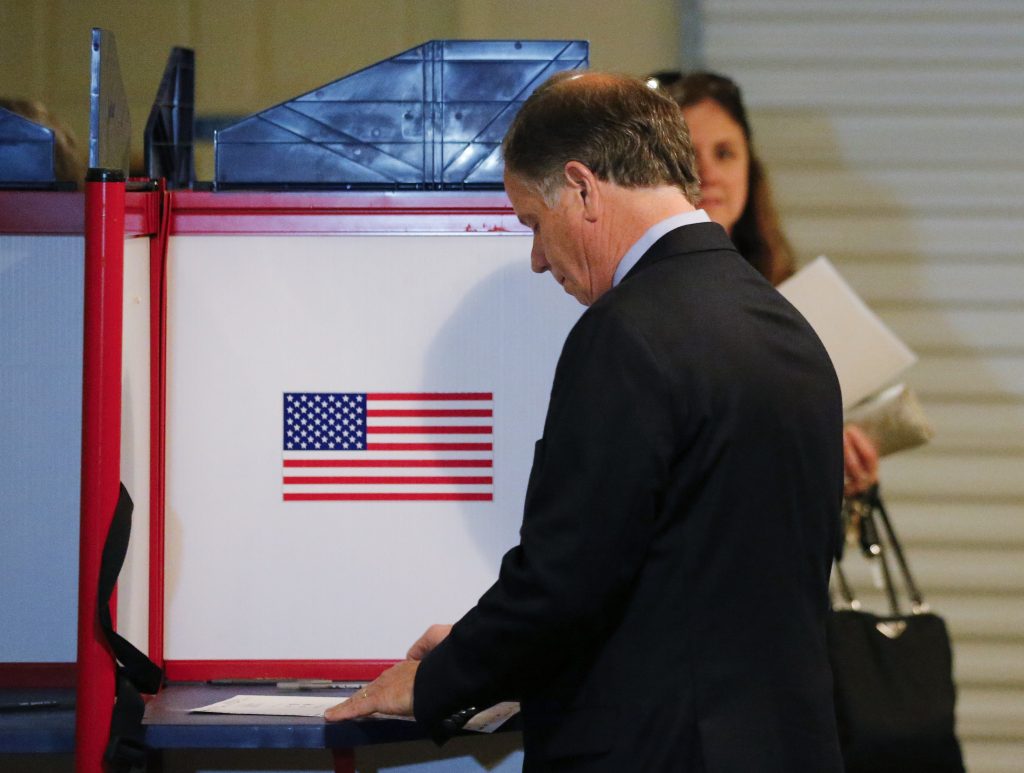 Democratic candidate for U.S. Senate Doug Jones casts his ballot Tuesday, Dec. 12, 2017, in Mountain Brook , Ala. Jones is facing Republican Roy Moore.