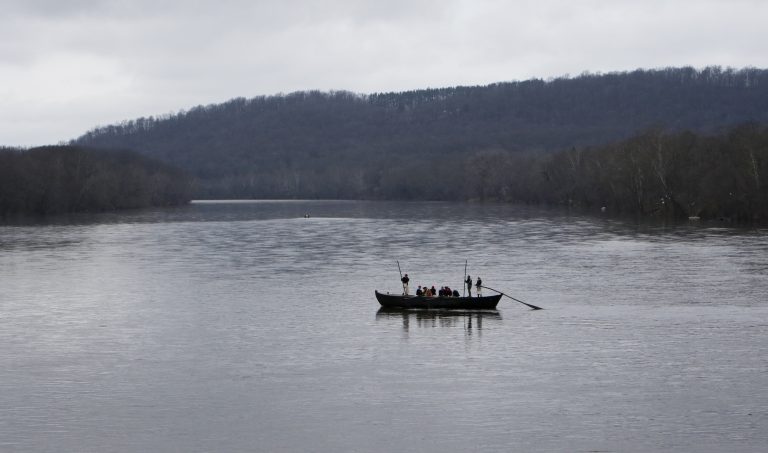 FILE- In this Dec. 25, 2015, file photo, a group of Revolutionary War re-enactors row a Durham boat during the re-enactment of Washington crossing the Delaware River, in Washington Crossing, Pa. Re-enactors might not be able to make their annual Christmas Day trip across the Delaware River between Pennsylvania and New Jersey because low water levels make it impossible for them to navigate their wooden Durham boats.