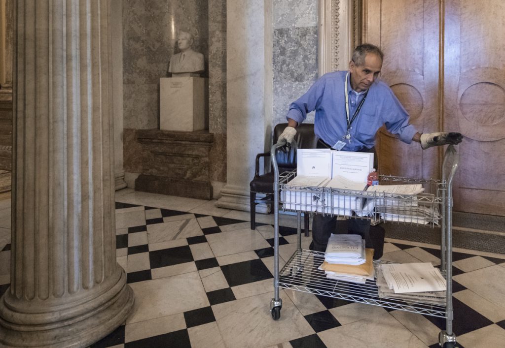 Walter Arandia After senators worked past midnight to pass the Republican tax bill, Walter Arandia distributes copies of the daily legislative calendar before lawmakers return, on Capitol Hill, in Washington, early Wednesday, Dec. 20, 2017.