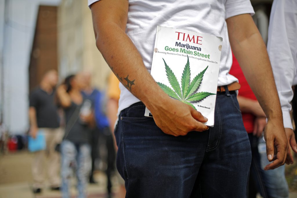Medical Marijuana Job Fair Michael Cole of Clairton, Pa., holds a Time magazine while waiting in line in downtown McKeesport, Pa., to attend a Medical Marijuana Job Fair, Thursday, July 27, 2017. (Gene J. Puskar/AP Photo)