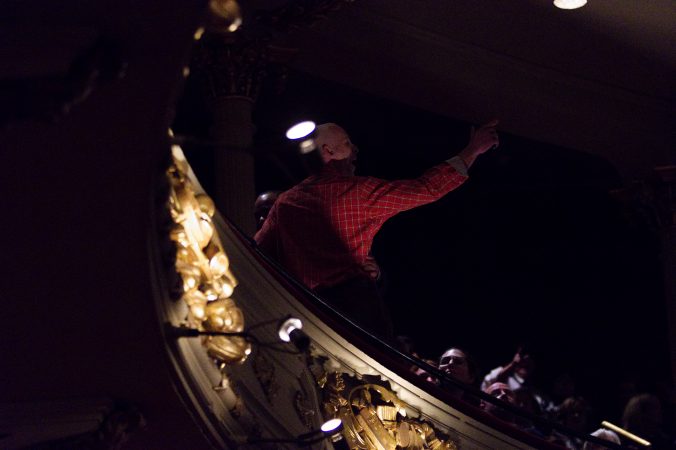 Protestor Howard Caplan, of Northeast Philadelphia shouts a question from the balcony to Hillary Clinton on stage, at the Academy of Music, on Thursday. (Bastiaan Slabbers for WHYY)