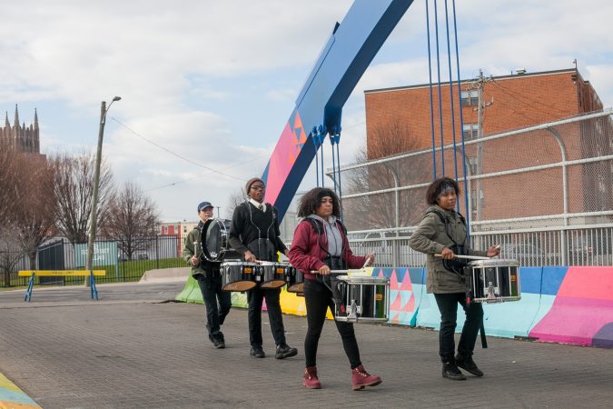 Kensington High School for the Creative and Performing Arts students Ebany Centeno, Marvelis Lima, Laquan Drago and Michael Colon performed on the B Street Bridge in Kensington before the dedication ceremony for a recently completed mural on the bridge. (Brad Larrison for WHYY)