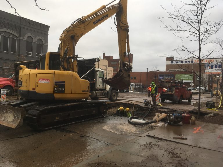 A crew works to repair a 20-inch water main break in Pittsburgh on Monday, Dec. 18. (Liz Reid/WESA)