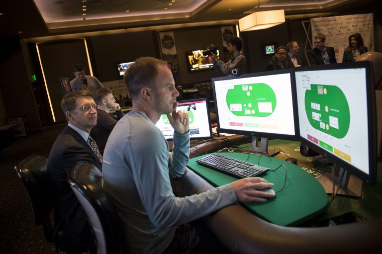 Professional poker player Jason Les sits in front of a computer and tries to beat an A.I. at the game.