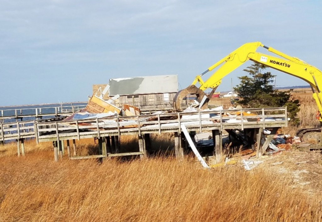 Screen Shot 2017-12-11 at 6.53.37 PM Heavy machinery is used to demolish a house along the Delaware Bay in Lawrence Township. (Image: New Jersey Department of Environmental Protection)