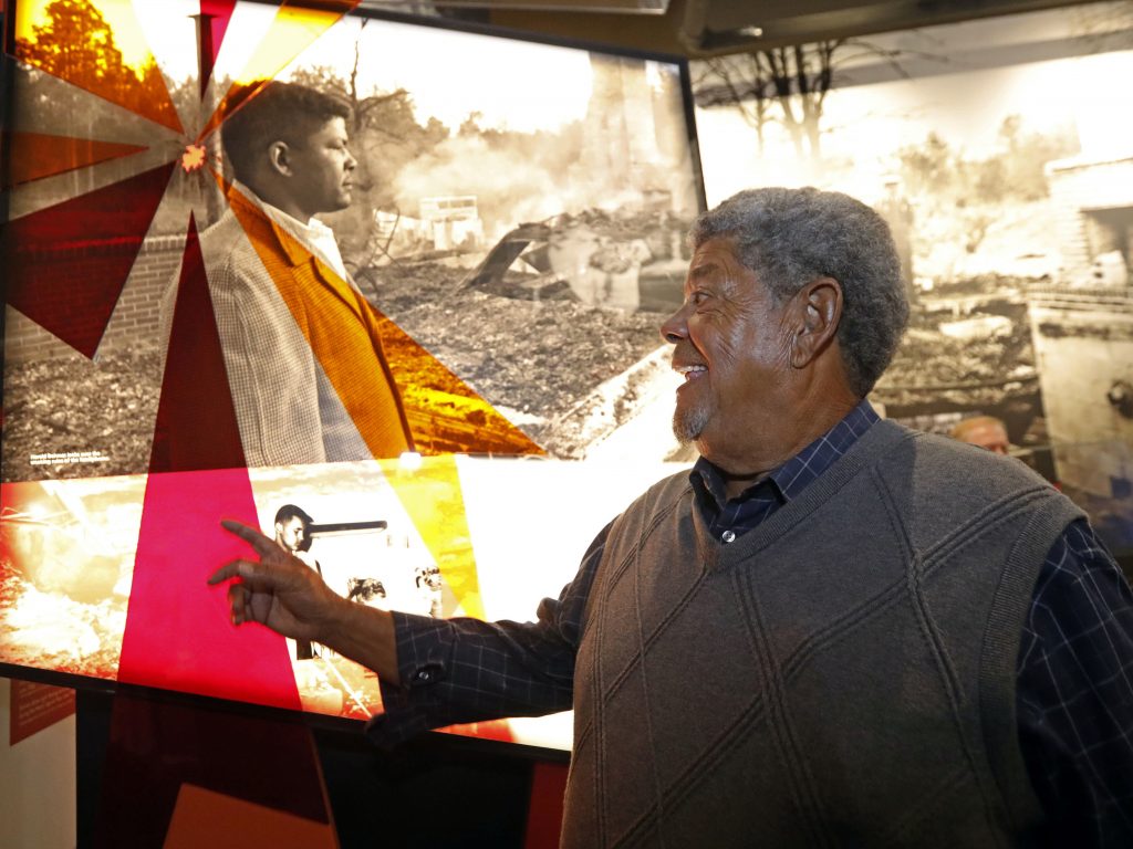 Harold Dahmer, whose father Vernon Dahmer was killed in 1966 by the Ku Klux Klan, smiles when he sees a photograph of his younger self on display at the Mississippi Civil Rights Museum. Harold Dahmer, whose father Vernon Dahmer was killed in 1966 by the Ku Klux Klan, smiles when he sees a photograph of his younger self on display at the Mississippi Civil Rights Museum. (Rogelio V. Solis/AP)
