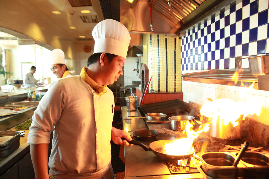 portrait of chef flambe cooking in the kitchen