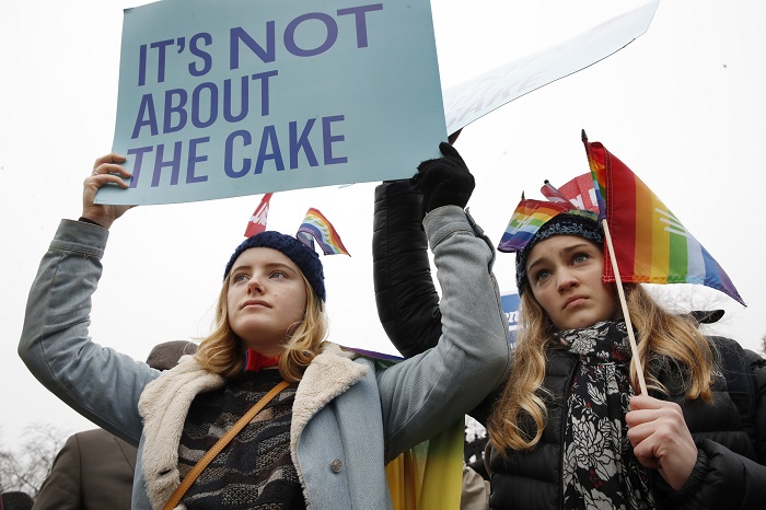 Lydia Macy, 17, left, and Mira Gottlieb, 16, both of Berkeley, Calif., rally outside of the Supreme Court which is hearing the 'Masterpiece Cakeshop v. Colorado Civil Rights Commission' today, Tuesday, Dec. 5, 2017, in Washington. (AP Photo/Jacquelyn Martin)