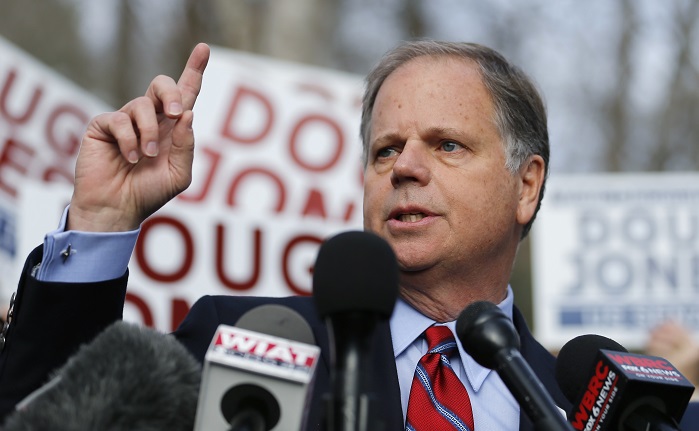 Democratic candidate for U.S. Senate Doug Jones speaks to reporters after casting his ballot Tuesday, Dec. 12, 2017, in Mountain Brook , Ala.  Jones is facing Republican Roy Moore. (AP Photo/John Bazemore)