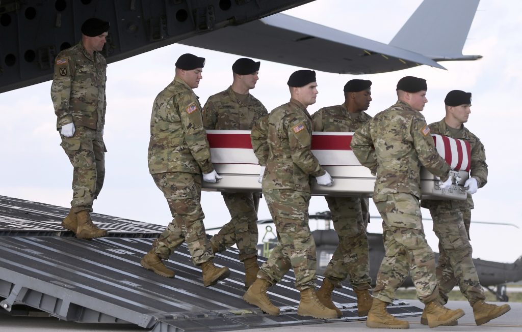 An Army team at Dover Air Force Base, Del., carries a transfer case containing the remains of Sgt. 1st Class Hughton O. Brown on Nov. 16.