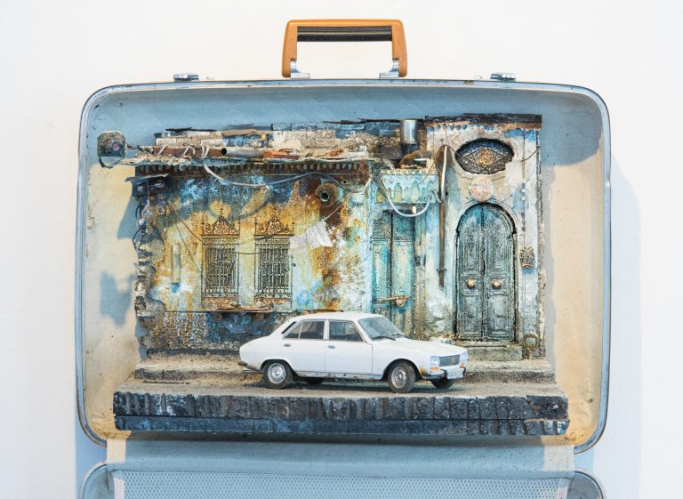 The white Peugeot 405, the vehicle of choice for the Syrian secret police, is parked outside a home in Damascus. In the diorama's upper left corner hangs a camera, suggesting surveillance.
(Rodney Nelson)