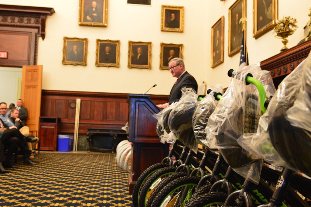 kenney and bikes Mayor Jim Kenney speaks before giving away new bikes Wednesday at a City Hall ceremony. (Tom MacDonald/WHYY)