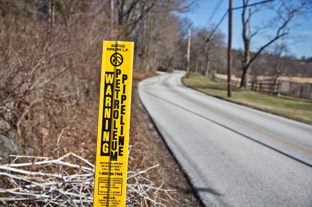 stream-and-del-river-and-pipeline-sign-1-of-1-2 A sign marks the path of the Mariner East 1 pipeline through Chester County. (Kimberly Paynter/WHYY)