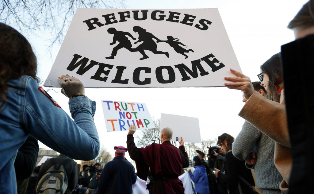 Protesters hold signs near the White House during a protest about President Trump’s immigration policies. A proposed presidential action would freeze immigration from mostly Muslim countries. Protesters hold signs near the White House during a protest about President Trump's immigration policies. A proposed presidential action would freeze immigration from mostly Muslim countries.
(Alex Brandon/AP)