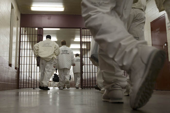 In this Jan. 18, 2011 photo, inmates at William E. Donaldson prison in Bessemer, Ala., return to their cells after completing meditation classes. Vipassana is a meditative technique that dates back 2,500 years to Gotama Buddha. Vipassana courses are held four times a year in the prison gymnasium, where as many as 40 inmate volunteers meditate 10 hours a day and live for the duration. (AP Photo/Dave Martin)