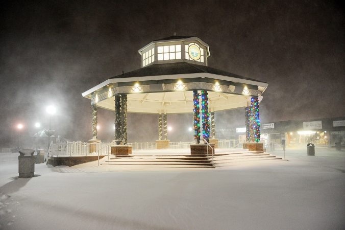 Swirling snow is illuminated by Christmas lights around the Rehoboth Beach bandstand. (Chuck Snyder/for WHYY)