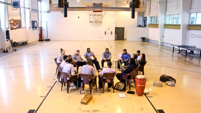 Inmates at Philadelphia Detention Center meet with Hannibal Lokumbe in the prison gym for music and soul searching. (Emma Lee/WHYY)