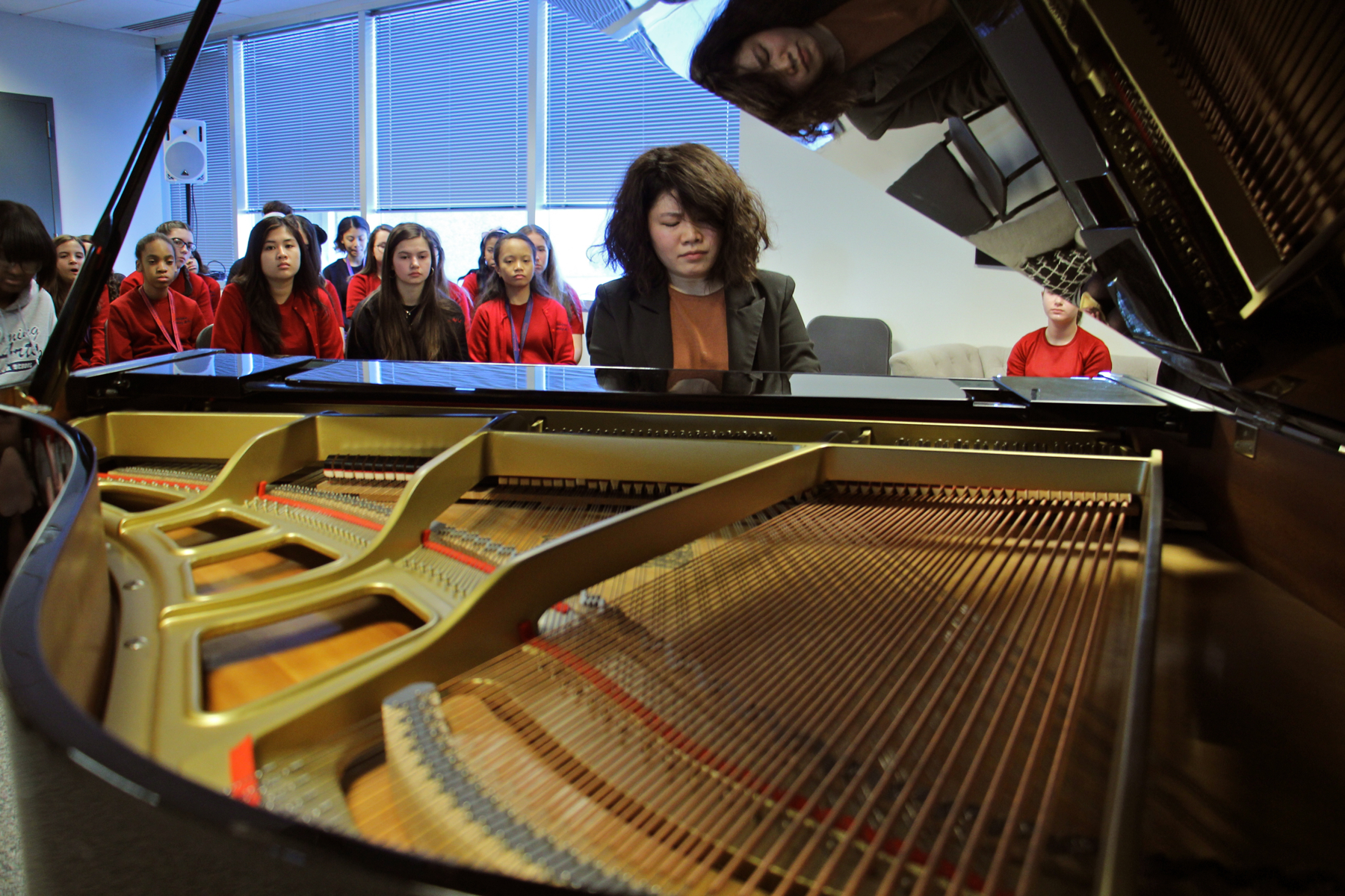 Zhenni Li performs for students after giving an hour-long master class.
