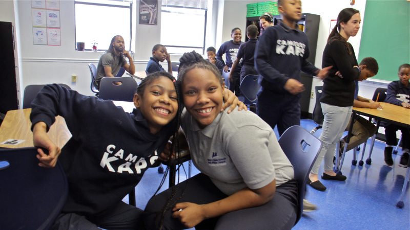 Taylor Norton (left) and Ada Whaley embrace during a music class at Camelot KAPS. (Emma Lee/WHYY)
