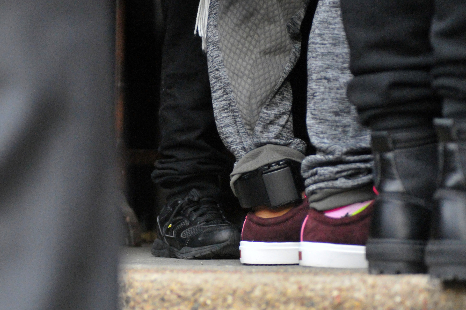 The ankle monitor worn by Camela Apolonio Hernandez is visible as she sees her children off in the doorway of her sanctuary at Church of the Advocate in North Philadelphia.