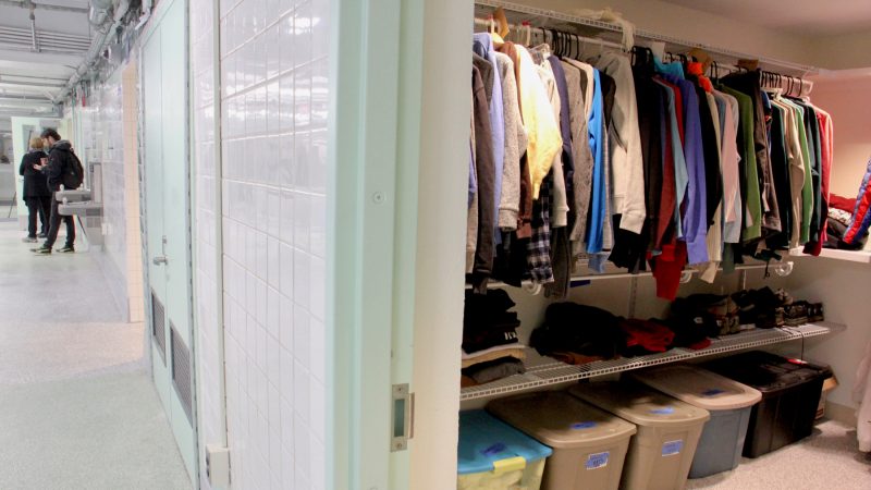 A spacious walk in closet at Hub of Hope is filled with donated clothing. (Emma Lee/WHYY)