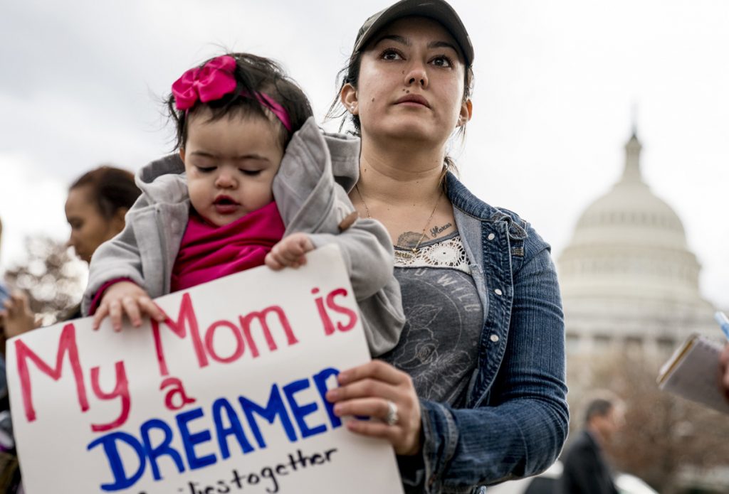 Yesenia Aguilar of Reading, Pa. holds her one year old daughter Denalli Urdaneta at an immigration rally on Capitol Hill in Washington, Tuesday, Jan. 23, 2018.  (Andrew Harnik/AP Photo)