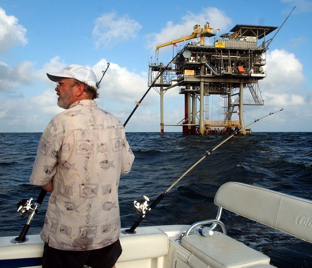 Obama Drilling FILE - In this Friday, May 9, 2003 file photo, angler Andy Hails, of Montgomery, Ala., checks the fishing lines on his boat as he trolls the Gulf of Mexico near a natural gas well off the Alabama coast near Gulf Shores, Ala. President Obama announced his new offshore drilling policy Wednesday, March 31, 2010. (AP Photo/Dave Martin, File)
