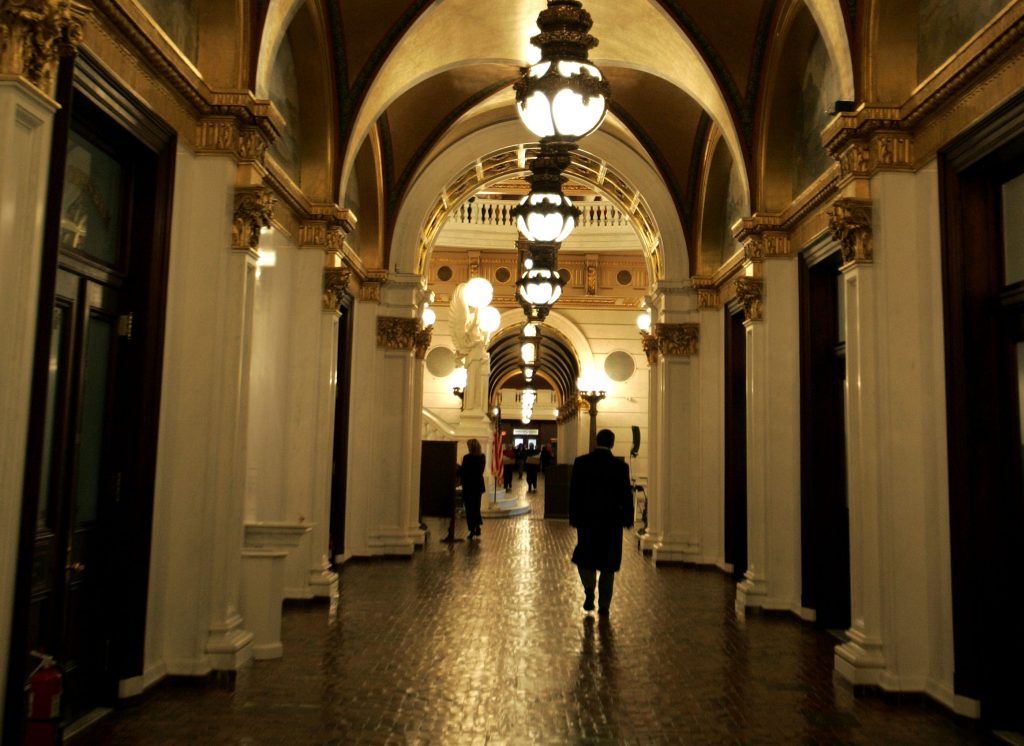 CHALLENGING INCUMBENTS I LEGISLATIVE BASTION A man walks down a hall toward the light of the Capitol rotunda, in Harrisburg, Pa.