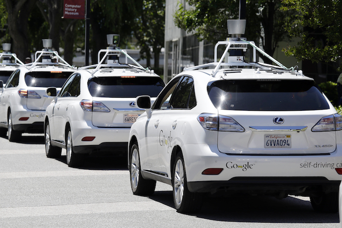FILE - This May 13, 2014, file photo shows a row of Google self-driving Lexus cars at a Google event outside the Computer History Museum in Mountain View, Calif. California regulators release safety reports filed by 11 companies that have been testing self-driving car prototypes on public roads on Wednesday, Feb. 1, 2017. The papers report the number of times in 2016 that human backup drivers took control from the cars' self-driving software, though companies argue such 
