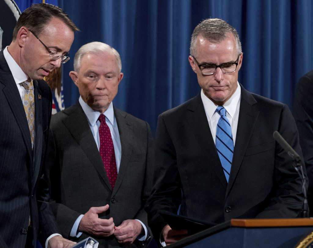 Jeff Sessions, Rod Rosenstein, Andrew McCabe FBI Acting Director Andrew McCabe, right, accompanied by Attorney General Jeff Sessions, second from left, Deputy Attorney General Rod Rosenstein, takes the podium at a news conference to announce an international cybercrime enforcement action at the Department of Justice, Thursday, July 20, 2017, in Washington.