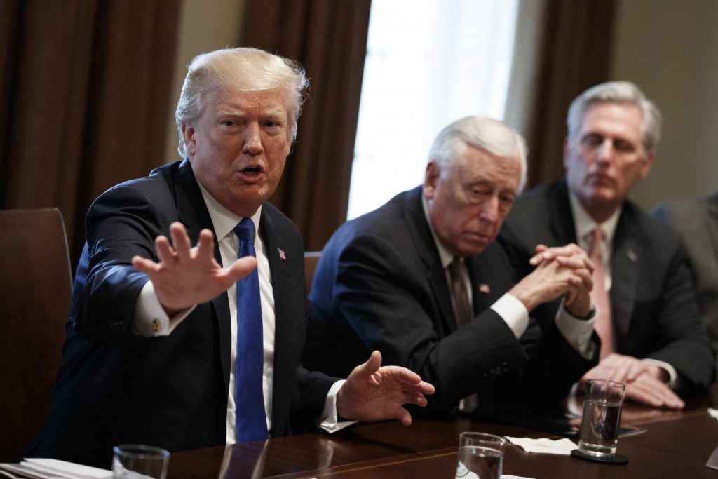 President Donald Trump speaks during a meeting with lawmakers on immigration policy in the Cabinet Room of the White House, Tuesday, Jan. 9, 2018, in Washington. From left, Trump, Rep. Steny Hoyer, D-Md., and Rep. Kevin McCarthy, R-Calif.