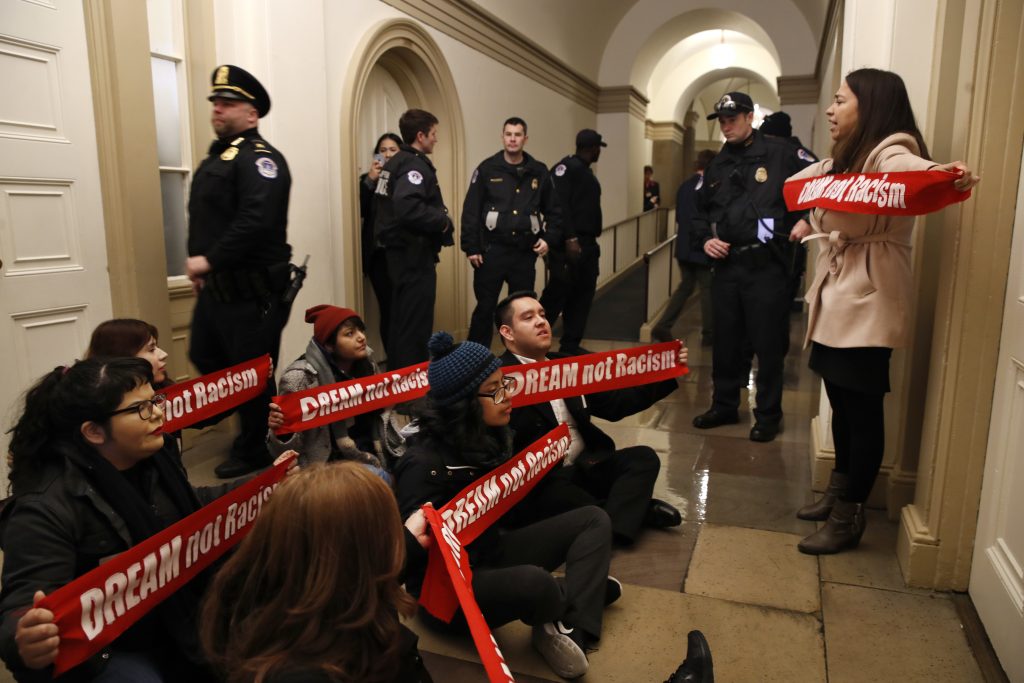 Diana Colin, right, with the Coalition for Humane Immigrant Rights (CHIRLA), shouts, 