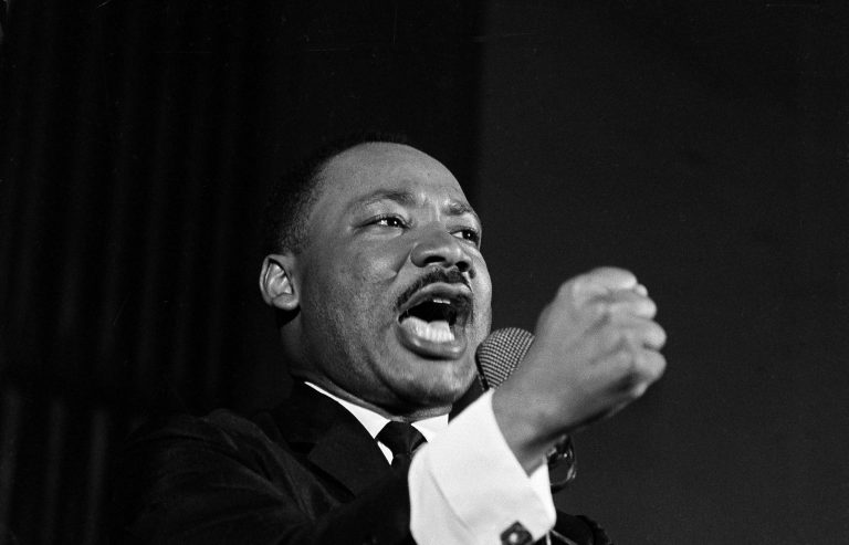Dr. Martin Luther King Jr. shakes his fist during a speech in Selma, Ala., Feb. 12, 1965. King was engaged in a battle with Sheriff Jim Clark over voting rights and voter registration in Selma. (AP Photo/Horace Cort)