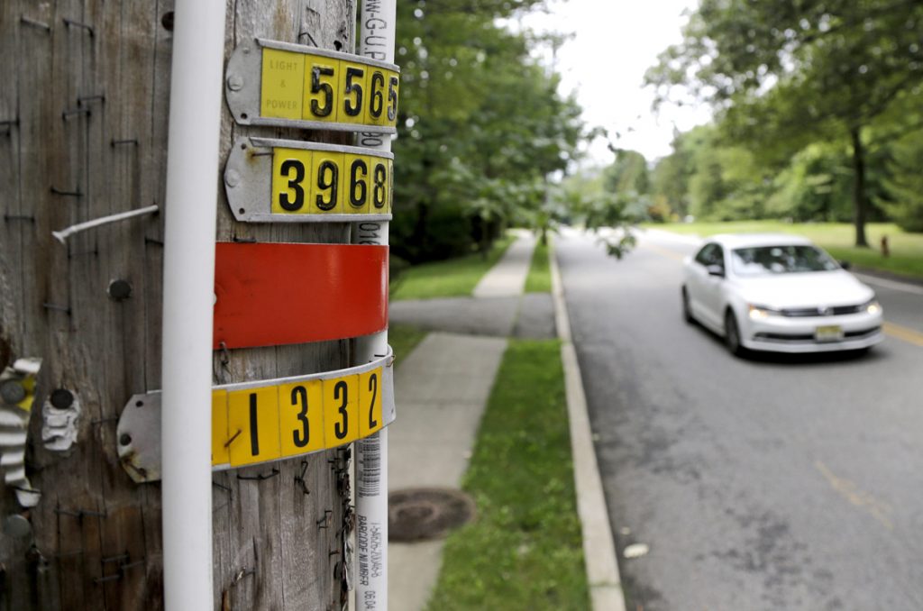 Park Ordinance Jewish Bias In this Aug. 5, 2017, file photo, a vehicle drives past polyvinyl chloride piping attached to a utility pole, signifying an outdoor area known as an eruv where Jewish residents observing certain restrictions during the Sabbath are permitted to carry items from home, along Airmount Road in Mahwah, N.J. The New Jersey state attorney general's office issued a subpoena to Mahwah township in August 2017 after the township adopted a rule limiting a public park to state residents, which opponents say targets the Jewish community from a nearby New York town. (Julio Cortez/AP Photo, File)