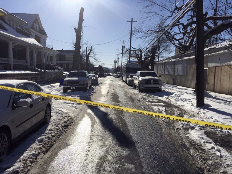 Crime tape stretches across a road near the scene of a shooting Thursday, Jan. 18, 2018, in Harrisburg, Pa. The mayor of Harrisburg said a U.S. marshal is dead after being shot while serving an arrest warrant in the city. Mayor Eric Papenfuse said two other officers were wounded in the Thursday morning shooting. (Marc Levy/AP Photo)