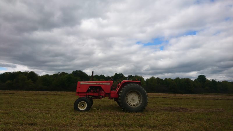A tractor sits in an empty field on the outskirts of the Titusville School District (Kevin McCorry/Keystone Crossroads)