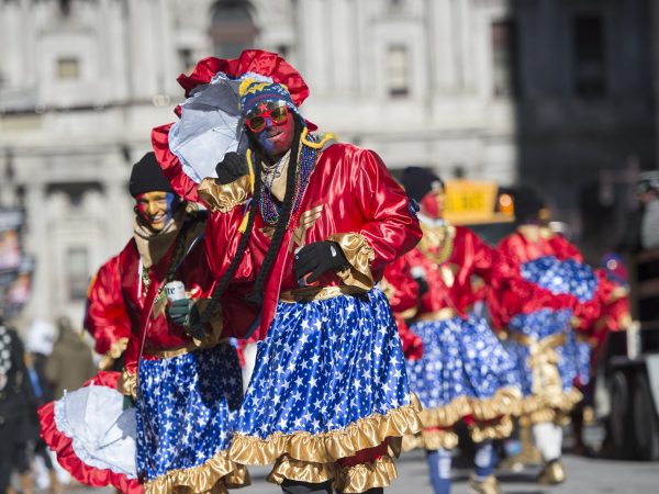 The Holly Rollers round City Hall as they march down Broad St.