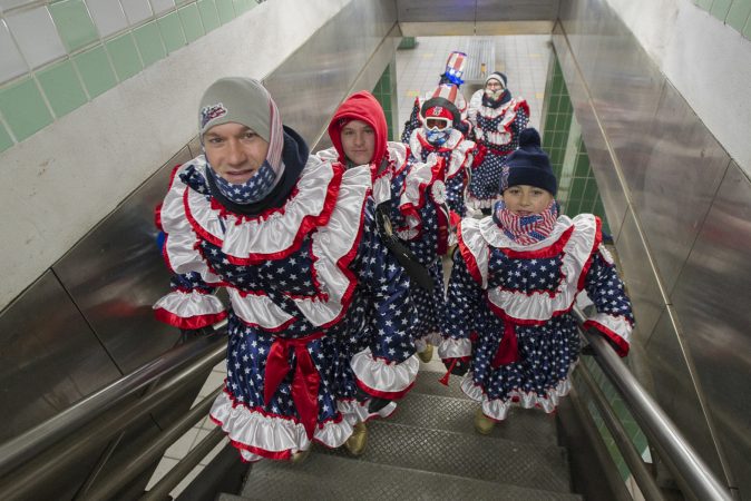 En route to the parade, a group of the Jesters New Years Brigade climb the stairs of the Spring Garden Station on the Broad Street Subway.