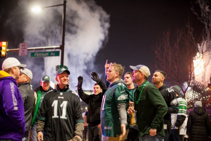 Eagles fans taunt a Vikings fan in South Philadelphia following their win over the Minnesota Vikings in the NFC Championship Game Sunday Night. (Brad Larrison for WHYY)