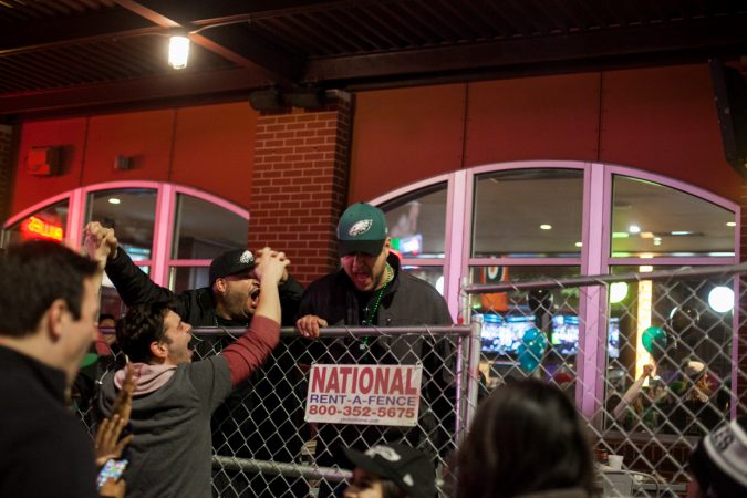 Eagles fans cheer outside of Xfinity Live after an Eagles touchdown in the NFC Championship Game against the Minnesota Viking Sunday Night. (Brad Larrison for WHYY)