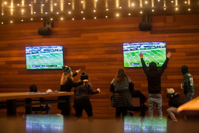 Eagles fans celebrate as the Eagles score yet another first half touchdown against the Minnesota Vikings in the NFC Championship Game Sunday Night. (Brad Larrison for NewsWorks)